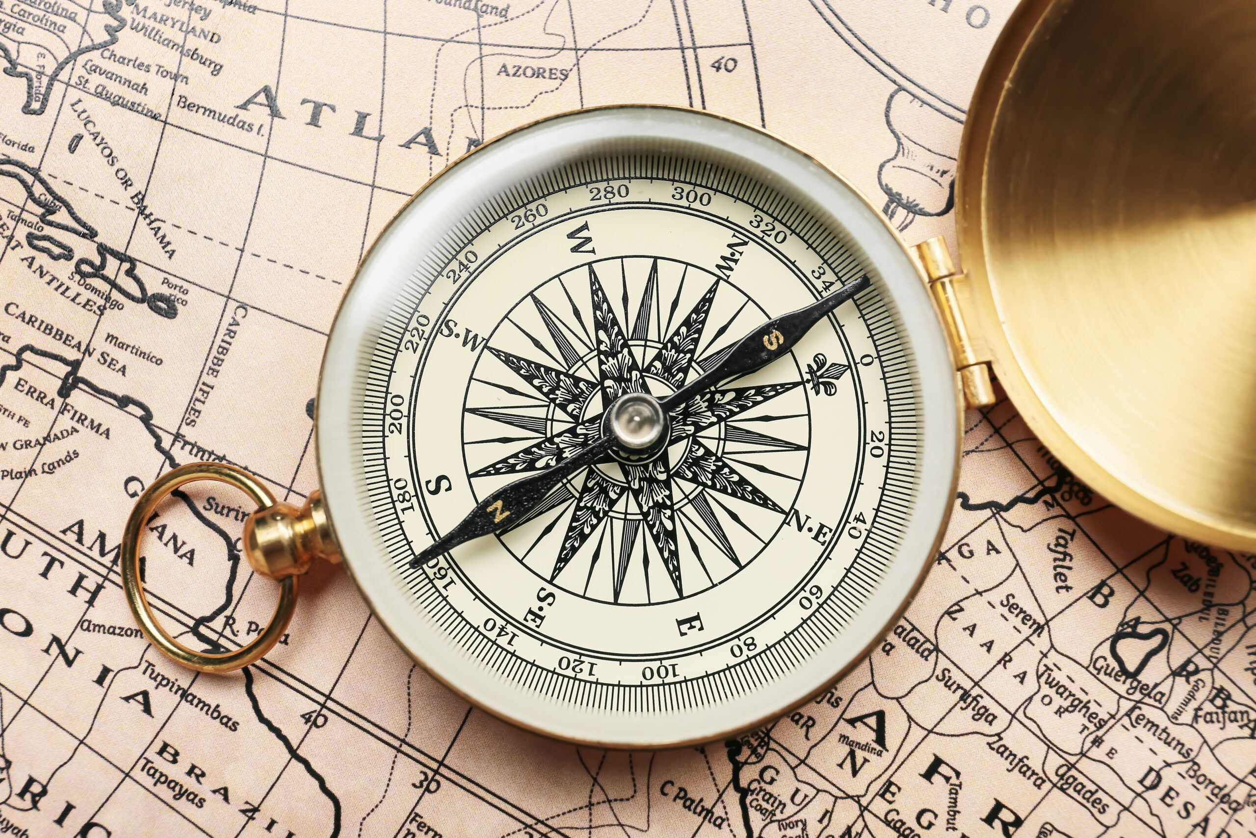 Dorlon Rep Purpose - Old compass on a vintage world map pointing to the goal
